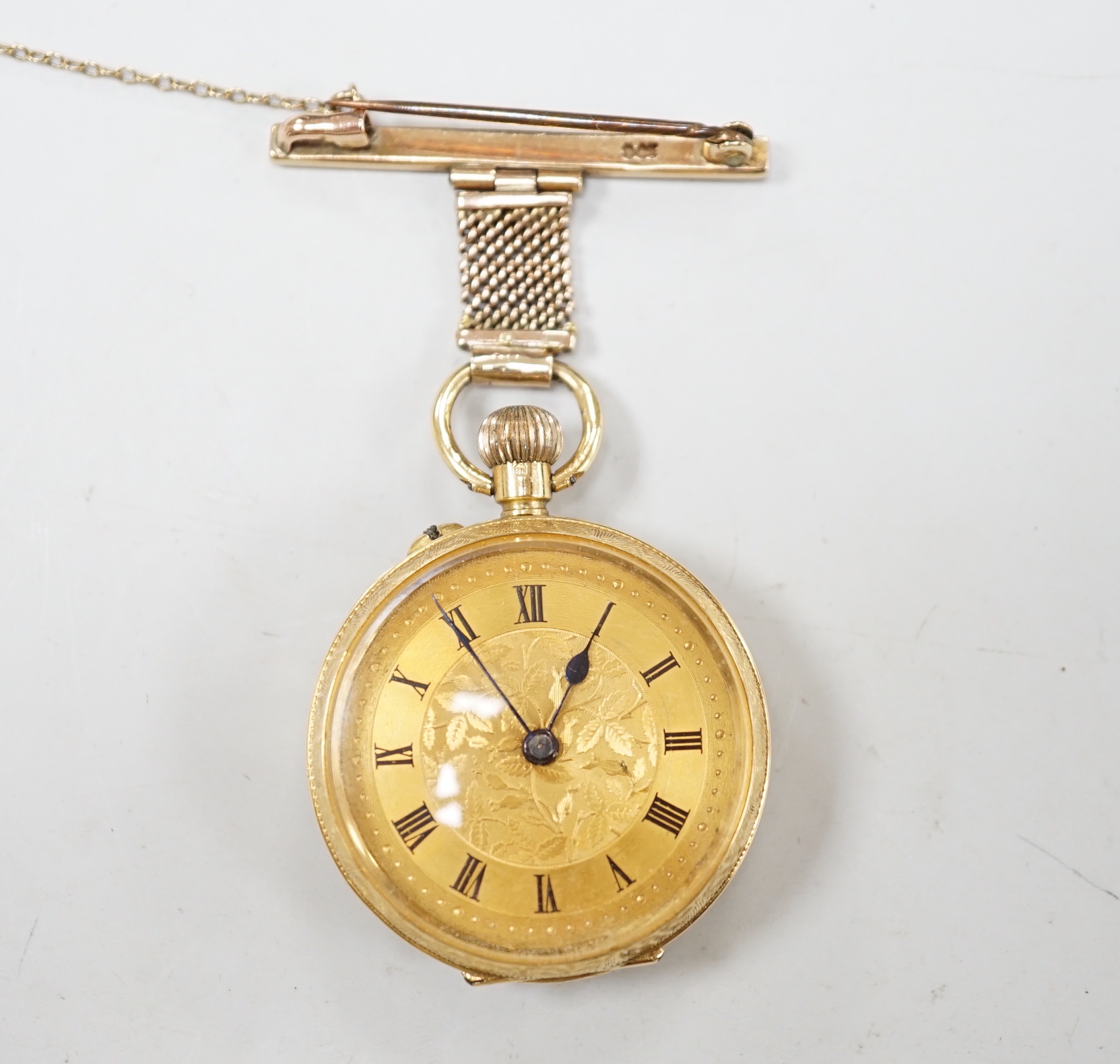 An early 20th century 18ct gold open face fob watch, with Roman dial, on a 9ct suspension brooch, gross weight 27.5 grams.